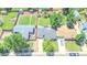 This aerial view showcases a home with a well-manicured lawn, mature trees, and a long driveway at 2294 W Parkhill Ave, Littleton, CO 80120