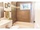 Recently renovated bathroom with tub, shower, modern fixtures, designer tile and natural lighting at 2294 W Parkhill Ave, Littleton, CO 80120