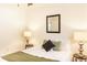 Bedroom featuring a comfortable bed with lamps and a large window at 2294 W Parkhill Ave, Littleton, CO 80120