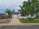 Charming ranch style home featuring a manicured lawn, wooden shutters, single car garage and mature shade tree at 2294 W Parkhill Ave, Littleton, CO 80120