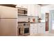 Kitchen with stainless steel appliances, granite counters, and open shelving at 2294 W Parkhill Ave, Littleton, CO 80120