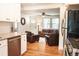 Open-concept living space with hardwood floors, lots of light, and views into the dining room and kitchen at 2294 W Parkhill Ave, Littleton, CO 80120