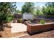 A patio with outdoor seating and wooden planters creates a welcoming backyard space at 2294 W Parkhill Ave, Littleton, CO 80120