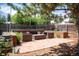 A patio with outdoor seating, surrounded by trees and landscaping, offers an ideal space for relaxation and entertaining at 2294 W Parkhill Ave, Littleton, CO 80120