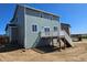 Backyard view of a two-story home with a deck, showing its spaciousness and potential for outdoor living at 6046 Keyser Pl, Brighton, CO 80601