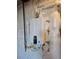 Tankless water heater in unfinished basement at 6046 Keyser Pl, Brighton, CO 80601