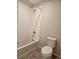 Bathroom with white tiled shower and tub combination and a white toilet at 6046 Keyser Pl, Brighton, CO 80601