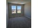 Bedroom with gray carpet and two windows overlooking the exterior at 6046 Keyser Pl, Brighton, CO 80601