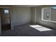 Bedroom with carpet, large window, and several electric outlets and switches, showing convenience at 6046 Keyser Pl, Brighton, CO 80601