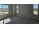Bright bedroom with large windows, carpeted floors, offering natural light and comfort at 6046 Keyser Pl, Brighton, CO 80601