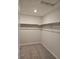 Walk-in closet with carpeting and shelves, providing ample space for storage and organization at 6046 Keyser Pl, Brighton, CO 80601