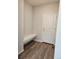 Entryway with wood-look floors, a built-in bench, and a door to the outside at 6046 Keyser Pl, Brighton, CO 80601