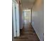 View of the hallway with wood floors, light-colored walls, and a view to another room at the end at 6046 Keyser Pl, Brighton, CO 80601