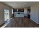 Open-concept kitchen with dark cabinets, a center island, and stainless steel appliances at 6046 Keyser Pl, Brighton, CO 80601