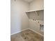Laundry room with tile floors and washer/dryer hookups and utility shelf at 6046 Keyser Pl, Brighton, CO 80601