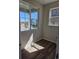 Bright room featuring wood floors and view of neighborhood through windows at 6046 Keyser Pl, Brighton, CO 80601