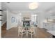 Bright dining room features a fireplace, a modern light fixture, and a glass table with seating for four at 242 Clementina St, Louisville, CO 80027