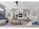 Stylish living room with a fireplace, modern decor, and an open view to the adjacent kitchen at 242 Clementina St, Louisville, CO 80027