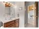 Neat bathroom features wooden vanity, white countertop, wallpaper, tile floor, and a step-in shower at 25019 N Mountain Park Dr, Evergreen, CO 80439