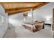 Bright and airy bedroom with vaulted wood ceiling, and natural light streaming through multiple windows at 25019 N Mountain Park Dr, Evergreen, CO 80439