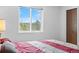 Bright bedroom with a large window offering natural light and closet at 25019 N Mountain Park Dr, Evergreen, CO 80439