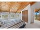 Cozy bedroom with vaulted wood ceiling, closet, carpeted floor, and natural light from multiple windows at 25019 N Mountain Park Dr, Evergreen, CO 80439