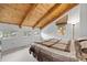 Bedroom featuring vaulted wood ceilings, multiple windows, and a queen bed with a brown patterned comforter at 25019 N Mountain Park Dr, Evergreen, CO 80439