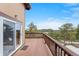 Spacious wooden deck offering stunning mountain views and seamless indoor-outdoor living with sliding glass doors at 25019 N Mountain Park Dr, Evergreen, CO 80439