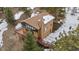 A captivating view of the home's exterior with surrounding trees and deck at 25019 N Mountain Park Dr, Evergreen, CO 80439