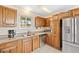 Well-lit kitchen with stainless steel appliances, generous cabinet space, and a granite countertop with a double sink at 25019 N Mountain Park Dr, Evergreen, CO 80439