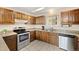 Traditional kitchen with stainless steel appliances, granite counters, and plenty of wooden cabinet space at 25019 N Mountain Park Dr, Evergreen, CO 80439