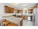 Traditional kitchen with wood cabinets, granite countertops, and stainless steel appliances at 25019 N Mountain Park Dr, Evergreen, CO 80439