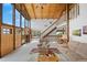 Comfortable living room with staircase, ample seating, a fireplace, and floor-to-ceiling windows at 25019 N Mountain Park Dr, Evergreen, CO 80439