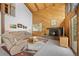 Inviting living room featuring a cozy fireplace, comfortable seating, and natural light at 25019 N Mountain Park Dr, Evergreen, CO 80439