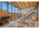 Comfortable living room with staircase, offering ample seating, a ceiling fan, and natural light at 25019 N Mountain Park Dr, Evergreen, CO 80439