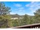 Scenic mountain view from a home's deck, showcasing the natural landscape and clear sky at 25019 N Mountain Park Dr, Evergreen, CO 80439