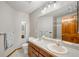 Bathroom featuring a double vanity, large mirror, tile flooring, and shower and bath combination at 17705 W 63Rd Dr, Golden, CO 80403