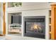 Close-up view of a fireplace and built-in shelving unit in the living room with a television at 17705 W 63Rd Dr, Golden, CO 80403