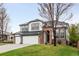 Charming two-story home with a well-manicured lawn and three car garage at 17705 W 63Rd Dr, Golden, CO 80403
