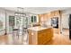 Bright kitchen featuring an island with seating, modern appliances, and ample counter space at 17705 W 63Rd Dr, Golden, CO 80403