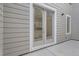 Back porch featuring beige wood panels and view from the back door with kitchen details reflecting in the glass at 710 Belay St, Erie, CO 80516