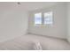 A clean bedroom with neutral carpet and multiple windows offers an inviting atmosphere at 710 Belay St, Erie, CO 80516