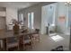 Sun-filled dining room with modern lighting and seating, open to the kitchen at 710 Belay St, Erie, CO 80516