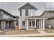 Charming two-story home boasts a welcoming front porch and modern gray and tan siding details at 710 Belay St, Erie, CO 80516