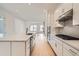 Modern kitchen with stainless appliances, large island and beautiful backsplash at 710 Belay St, Erie, CO 80516