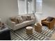 Cozy living room with neutral sofa, patterned rug, and ample natural light at 710 Belay St, Erie, CO 80516