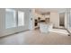 Spacious layout connects bright living room with white cabinets and kitchen island at 710 Belay St, Erie, CO 80516