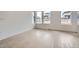 Sun-drenched living room boasting beautiful hardwood floors and large windows at 710 Belay St, Erie, CO 80516