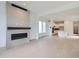 Open-concept living room featuring stylish fireplace and easy flow to kitchen at 710 Belay St, Erie, CO 80516