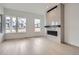 A modern living room with a fireplace and an abundance of natural light from the large windows at 710 Belay St, Erie, CO 80516
